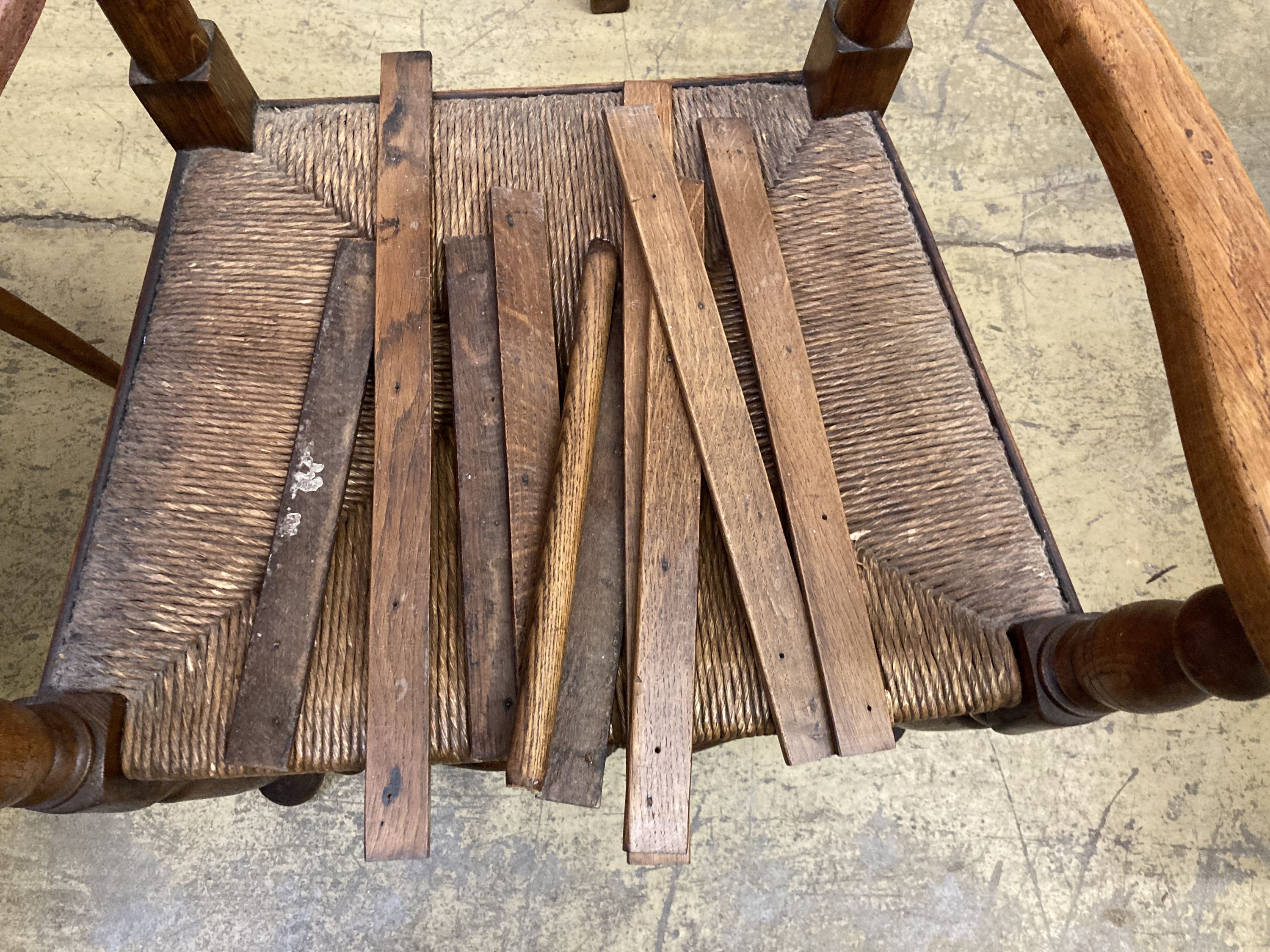 A set of six ladderback dining chairs with rush seats, two having arms